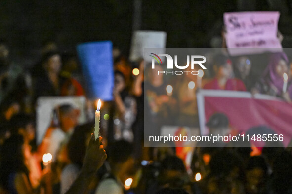 Bangladeshi women protesters are holding candlelight during the protest against rape in Dhaka, Bangladesh, on August 17, 2024. Women are mar...