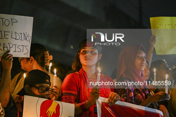 Bangladeshi women protesters are holding candlelight during the protest against rape in Dhaka, Bangladesh, on August 17, 2024. Women are mar...