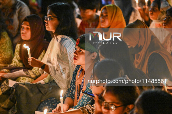 Bangladeshi women protesters are holding candlelight during the protest against rape in Dhaka, Bangladesh, on August 17, 2024. Women are mar...