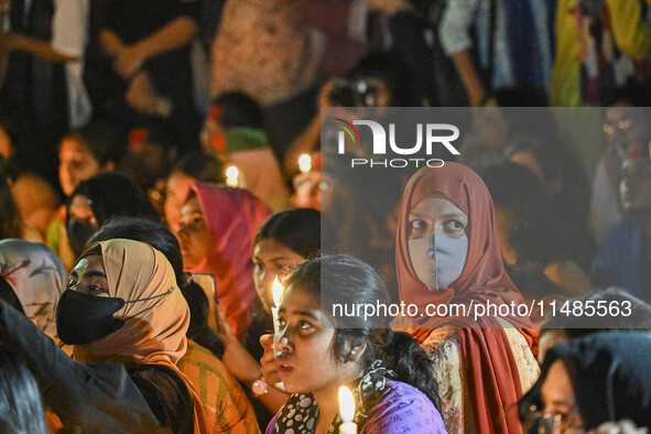 Bangladeshi women protesters are holding candlelight during the protest against rape in Dhaka, Bangladesh, on August 17, 2024. Women are mar...