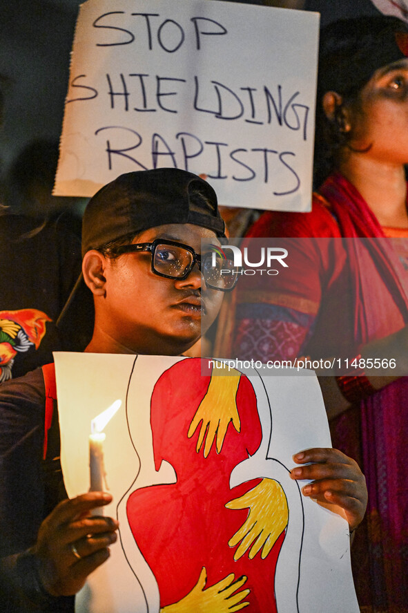 Bangladeshi women protesters are holding candles and placards during the protest against rape in Dhaka, Bangladesh, on August 17, 2024. Wome...