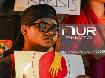 Bangladeshi women protesters are holding candles and placards during the protest against rape in Dhaka, Bangladesh, on August 17, 2024. Wome...