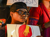 Bangladeshi women protesters are holding candles and placards during the protest against rape in Dhaka, Bangladesh, on August 17, 2024. Wome...