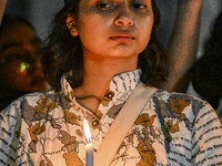 A Bangladeshi woman protester is holding a candlelight during the protest against rape in Dhaka, Bangladesh, on August 17, 2024. Women are m...