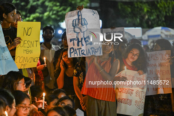 Bangladeshi women protesters are holding candles and placards during the protest against rape in Dhaka, Bangladesh, on August 17, 2024. Wome...