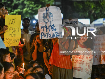 Bangladeshi women protesters are holding candles and placards during the protest against rape in Dhaka, Bangladesh, on August 17, 2024. Wome...