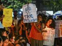 Bangladeshi women protesters are holding candles and placards during the protest against rape in Dhaka, Bangladesh, on August 17, 2024. Wome...