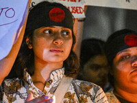 A Bangladeshi woman protester is holding a candlelight during the protest against rape in Dhaka, Bangladesh, on August 17, 2024. Women are m...