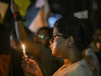 A Bangladeshi woman protester is holding a candlelight during the protest against rape in Dhaka, Bangladesh, on August 17, 2024. Women are m...