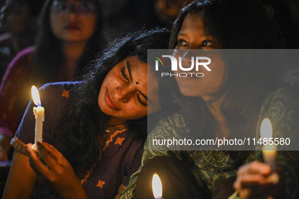 Bangladeshi women protesters are holding candlelight during the protest against rape in Dhaka, Bangladesh, on August 17, 2024. Women are mar...