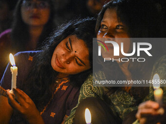 Bangladeshi women protesters are holding candlelight during the protest against rape in Dhaka, Bangladesh, on August 17, 2024. Women are mar...