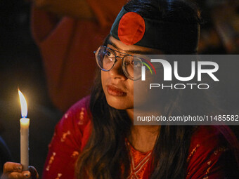 A Bangladeshi woman protester is holding a candlelight during the protest against rape in Dhaka, Bangladesh, on August 17, 2024. Women are m...