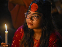 A Bangladeshi woman protester is holding a candlelight during the protest against rape in Dhaka, Bangladesh, on August 17, 2024. Women are m...