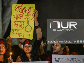 Bangladeshi women protesters are holding candles and placards during the protest against rape in Dhaka, Bangladesh, on August 17, 2024. Wome...