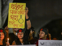 Bangladeshi women protesters are holding candles and placards during the protest against rape in Dhaka, Bangladesh, on August 17, 2024. Wome...