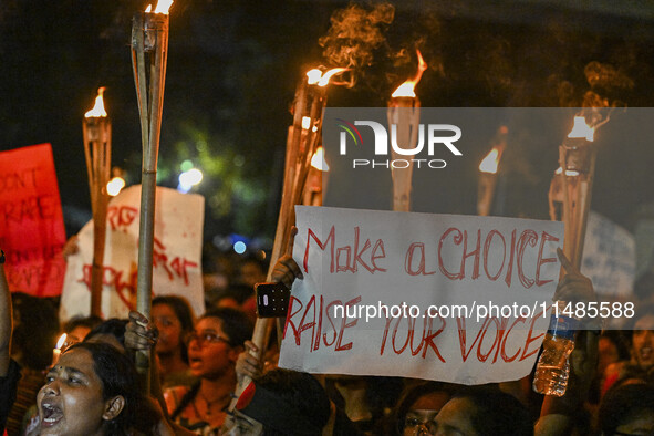 Bangladeshi women protesters are holding torches and placards during the protest against rape in Dhaka, Bangladesh, on August 17, 2024. Wome...