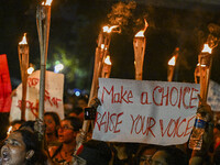 Bangladeshi women protesters are holding torches and placards during the protest against rape in Dhaka, Bangladesh, on August 17, 2024. Wome...