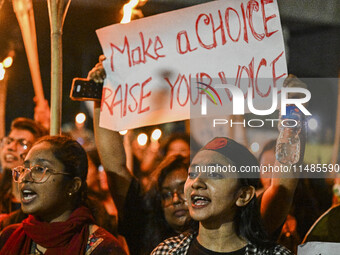 Bangladeshi women protesters are holding torches and placards during the protest against rape in Dhaka, Bangladesh, on August 17, 2024. Wome...