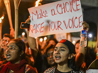 Bangladeshi women protesters are holding torches and placards during the protest against rape in Dhaka, Bangladesh, on August 17, 2024. Wome...