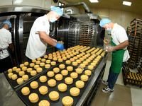 A worker is producing mooncakes at a food workshop in Hai'an, Jiangsu province, China, on August 16, 2024. (