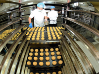 A worker is producing mooncakes at a food workshop in Hai'an, Jiangsu province, China, on August 16, 2024. (