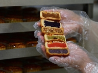 A worker is producing mooncakes at a food workshop in Hai'an, Jiangsu province, China, on August 16, 2024. (