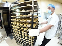 A worker is producing mooncakes at a food workshop in Hai'an, Jiangsu province, China, on August 16, 2024. (