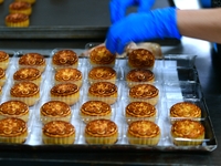 A worker is producing mooncakes at a food workshop in Hai'an, Jiangsu province, China, on August 16, 2024. (