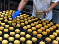 A worker is producing mooncakes at a food workshop in Hai'an, Jiangsu province, China, on August 16, 2024. (