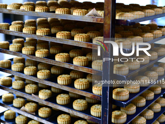 A worker is producing mooncakes at a food workshop in Hai'an, Jiangsu province, China, on August 16, 2024. (