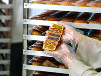 A worker is producing mooncakes at a food workshop in Hai'an, Jiangsu province, China, on August 16, 2024. (