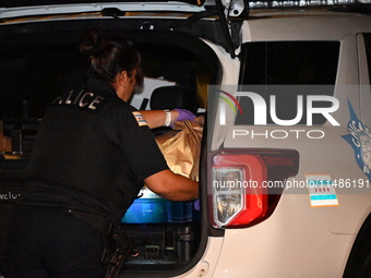 Evidence bags are being collected and put in the back of a Chicago police vehicle. A 28-year-old male victim is being shot numerous times an...