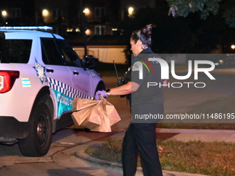 Evidence bags are being collected and put in the back of a Chicago police vehicle. A 28-year-old male victim is being shot numerous times an...