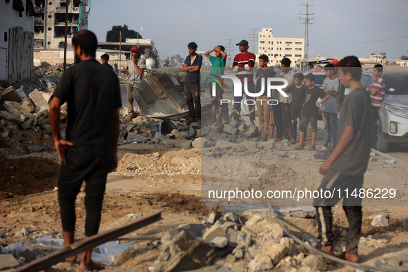 Palestinians are inspecting the site of an Israeli strike in al-Zawayda in the central Gaza Strip on August 17, 2024, amid the ongoing confl...