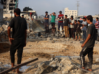 Palestinians are inspecting the site of an Israeli strike in al-Zawayda in the central Gaza Strip on August 17, 2024, amid the ongoing confl...