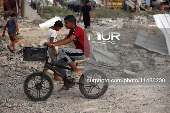 Palestinians are inspecting the site of an Israeli strike in al-Zawayda in the central Gaza Strip on August 17, 2024, amid the ongoing confl...