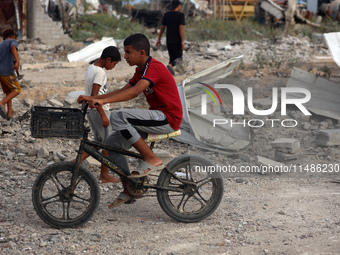 Palestinians are inspecting the site of an Israeli strike in al-Zawayda in the central Gaza Strip on August 17, 2024, amid the ongoing confl...