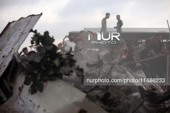 Palestinians are inspecting the site of an Israeli strike in al-Zawayda in the central Gaza Strip on August 17, 2024, amid the ongoing confl...