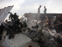 Palestinians are inspecting the site of an Israeli strike in al-Zawayda in the central Gaza Strip on August 17, 2024, amid the ongoing confl...