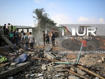 Palestinians are inspecting the site of an Israeli strike in al-Zawayda in the central Gaza Strip on August 17, 2024, amid the ongoing confl...