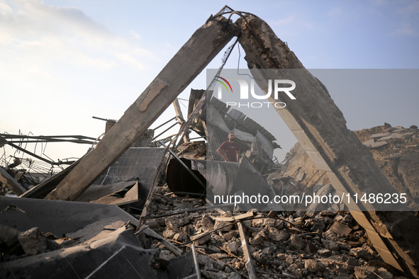 Palestinians are inspecting the site of an Israeli strike in al-Zawayda in the central Gaza Strip on August 17, 2024, amid the ongoing confl...