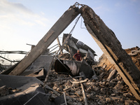 Palestinians are inspecting the site of an Israeli strike in al-Zawayda in the central Gaza Strip on August 17, 2024, amid the ongoing confl...