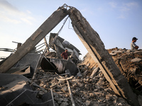 Palestinians are inspecting the site of an Israeli strike in al-Zawayda in the central Gaza Strip on August 17, 2024, amid the ongoing confl...