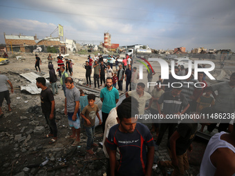 Palestinians are inspecting the site of an Israeli strike in al-Zawayda in the central Gaza Strip on August 17, 2024, amid the ongoing confl...