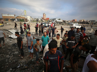 Palestinians are inspecting the site of an Israeli strike in al-Zawayda in the central Gaza Strip on August 17, 2024, amid the ongoing confl...