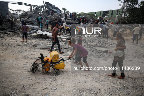 Palestinians are inspecting the site of an Israeli strike in al-Zawayda in the central Gaza Strip on August 17, 2024, amid the ongoing confl...