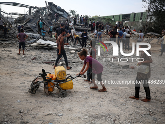 Palestinians are inspecting the site of an Israeli strike in al-Zawayda in the central Gaza Strip on August 17, 2024, amid the ongoing confl...