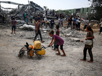 Palestinians are inspecting the site of an Israeli strike in al-Zawayda in the central Gaza Strip on August 17, 2024, amid the ongoing confl...