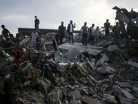 Palestinians are inspecting the site of an Israeli strike in al-Zawayda in the central Gaza Strip on August 17, 2024, amid the ongoing confl...