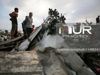 Palestinians are inspecting the site of an Israeli strike in al-Zawayda in the central Gaza Strip on August 17, 2024, amid the ongoing confl...